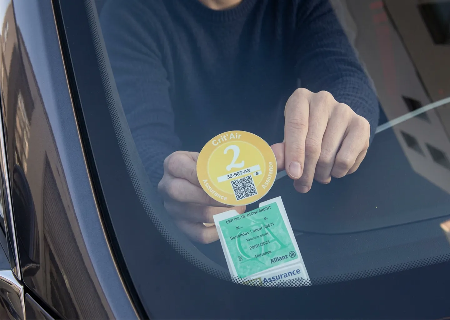 Vignette Crit'Air apposée sur un pare-brise, vérifiée en zone à faibles émissions